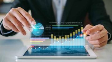 businessman-analyzing-company-financial-report-with-augmented-reality-graphic